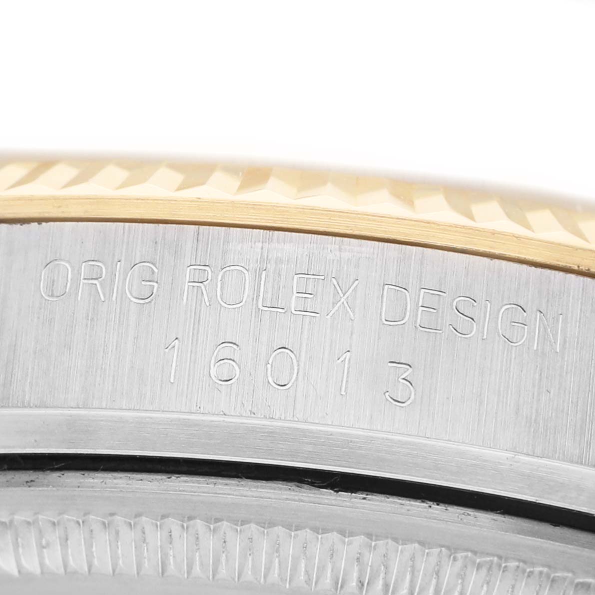 The image shows the side of a Rolex Datejust 16013 Men's Steel and Gold (two tone) Champagne Dial, focusing on the engraved model number and design details.