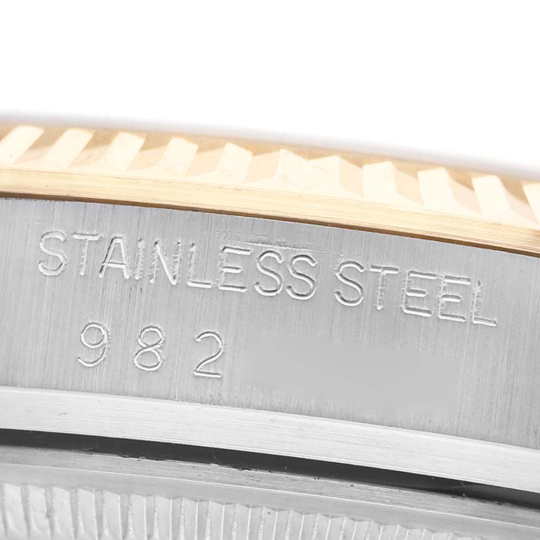 The image shows a close-up of the Rolex Datejust 16013 Men's Steel and Gold (two tone) Champagne Dial watch, highlighting the stainless steel material and engraved details.