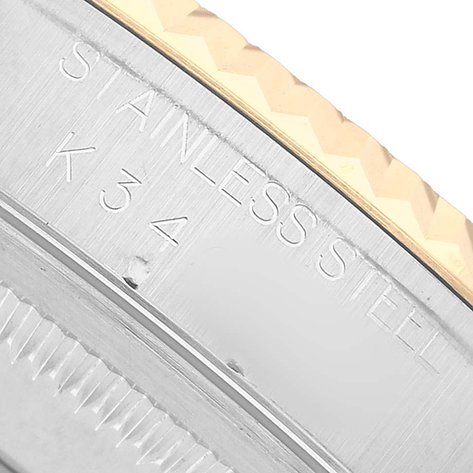 The image shows a close-up of the side of a Rolex Datejust 16233 Men's Steel and Gold (two tone) White Dial, highlighting the stainless steel part with engraving.