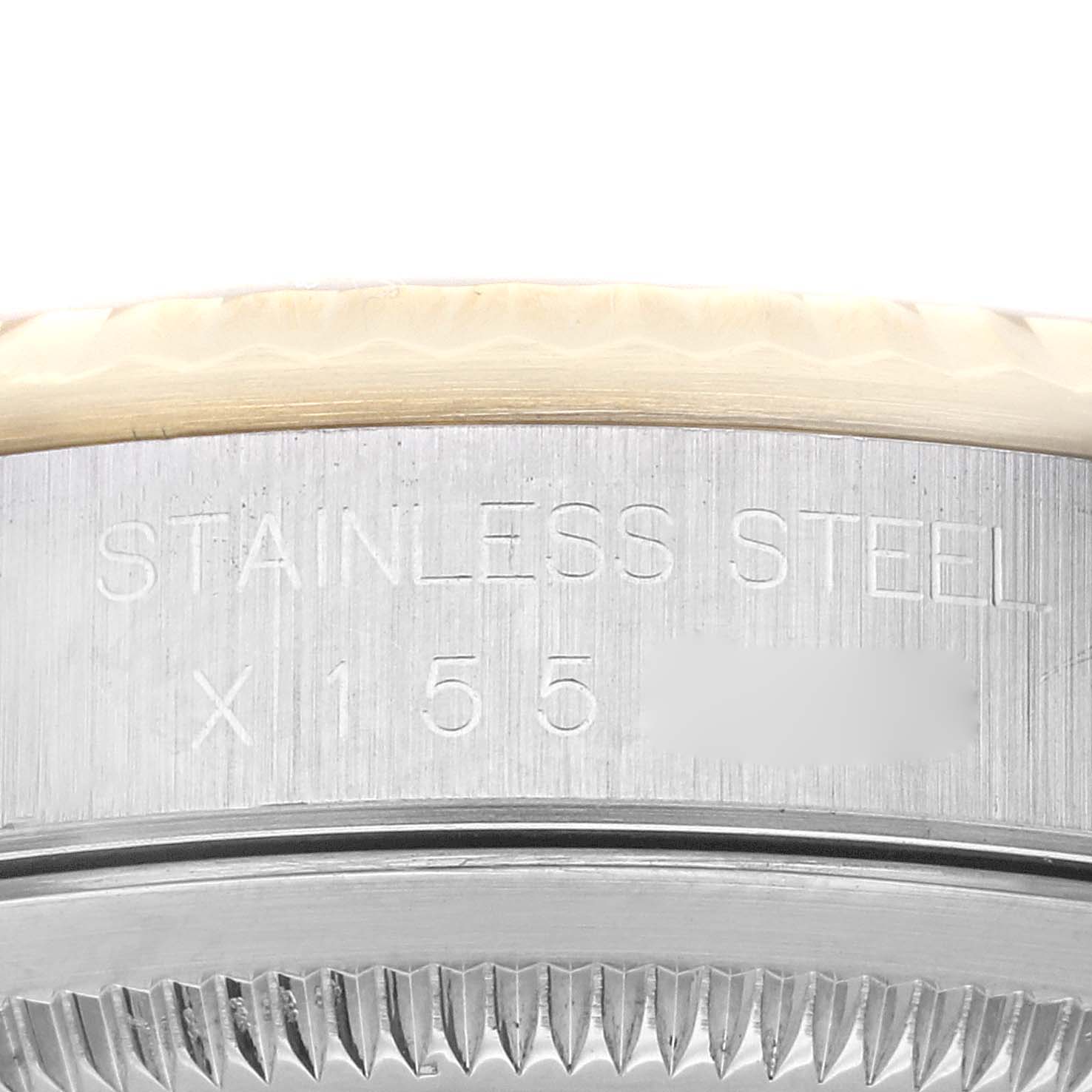 The image shows a close-up of the side of a Rolex Datejust 16233 Men's Steel and Gold (two tone) Champagne Dial 16233 Men's Steel and Gold (two tone) Champagne Dial watch case, highlighting "Stainless Steel" engraving.