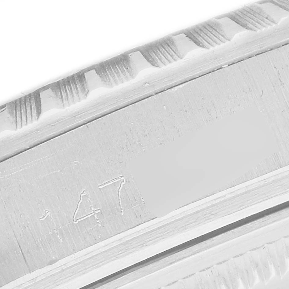 The image shows a close-up of the fluted bezel and engraved details of a Rolex Datejust 1603 Men
s Stainless Steel Silver Dial 1603 Men
s Stainless Steel Silver Dial watch.