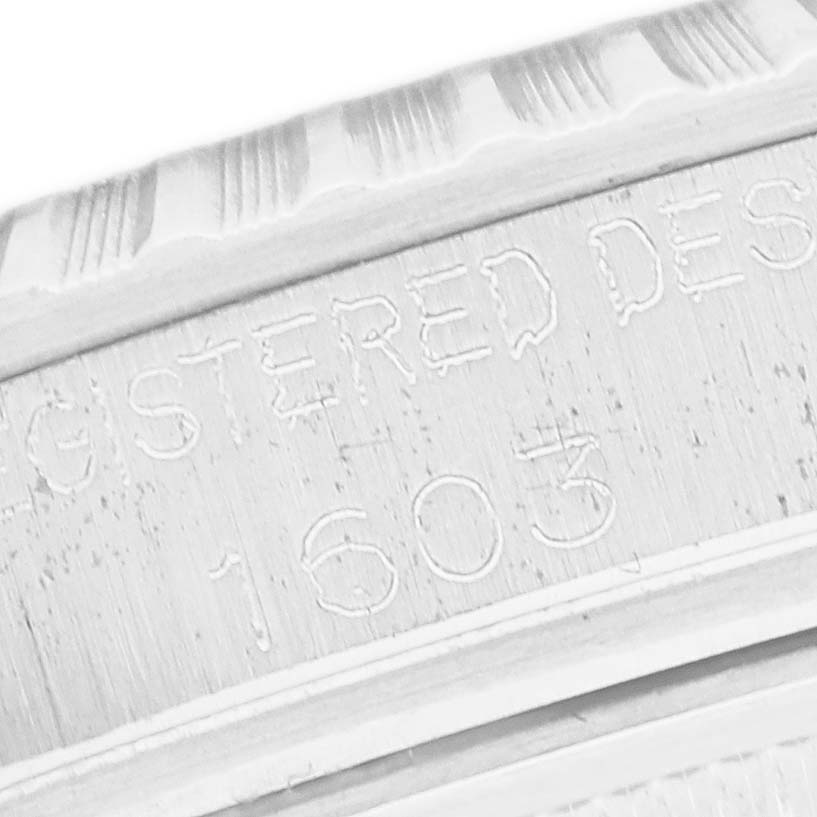 The image shows a close-up of the engraved text on the inner bezel of a Rolex Datejust 1603 Men
s Stainless Steel Silver Dial 1603 Men
s Stainless Steel Silver Dial watch.