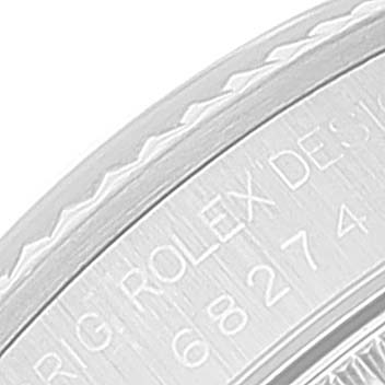 The image shows a close-up of the side engraving on a Rolex Mid-Size 68274 Women
s Stainless Steel Blue Dial 68274 Women
s Stainless Steel Blue Dial watch, including the model number and the "ROLEX DESIGN" inscription.