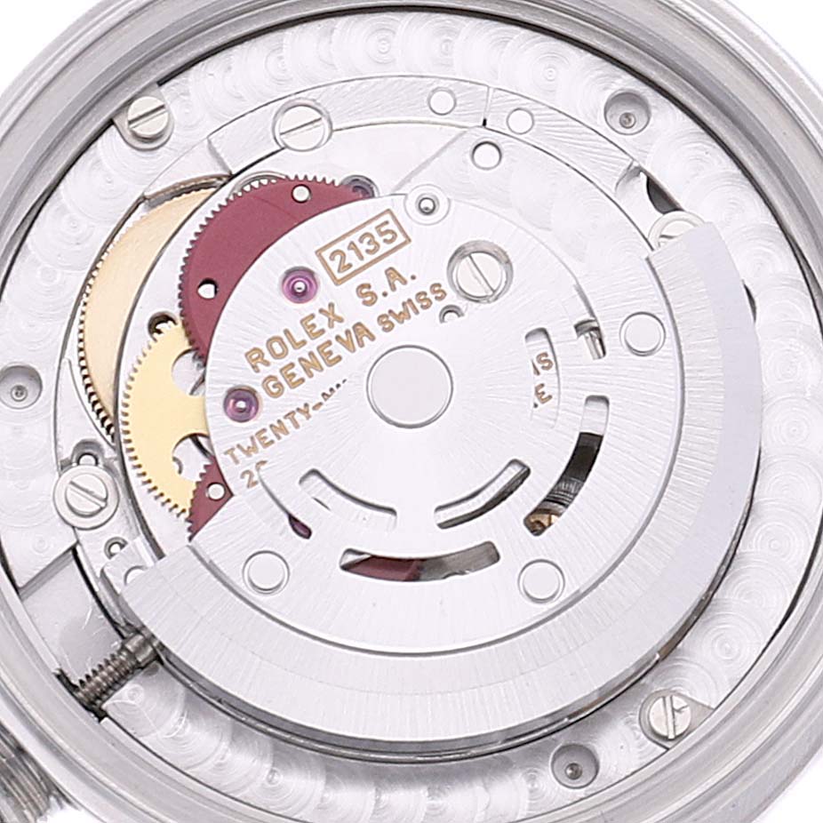 This image shows the inner mechanical movement of a Mid-Size Rolex watch, specifically the rotor, gears, and other intricate components.