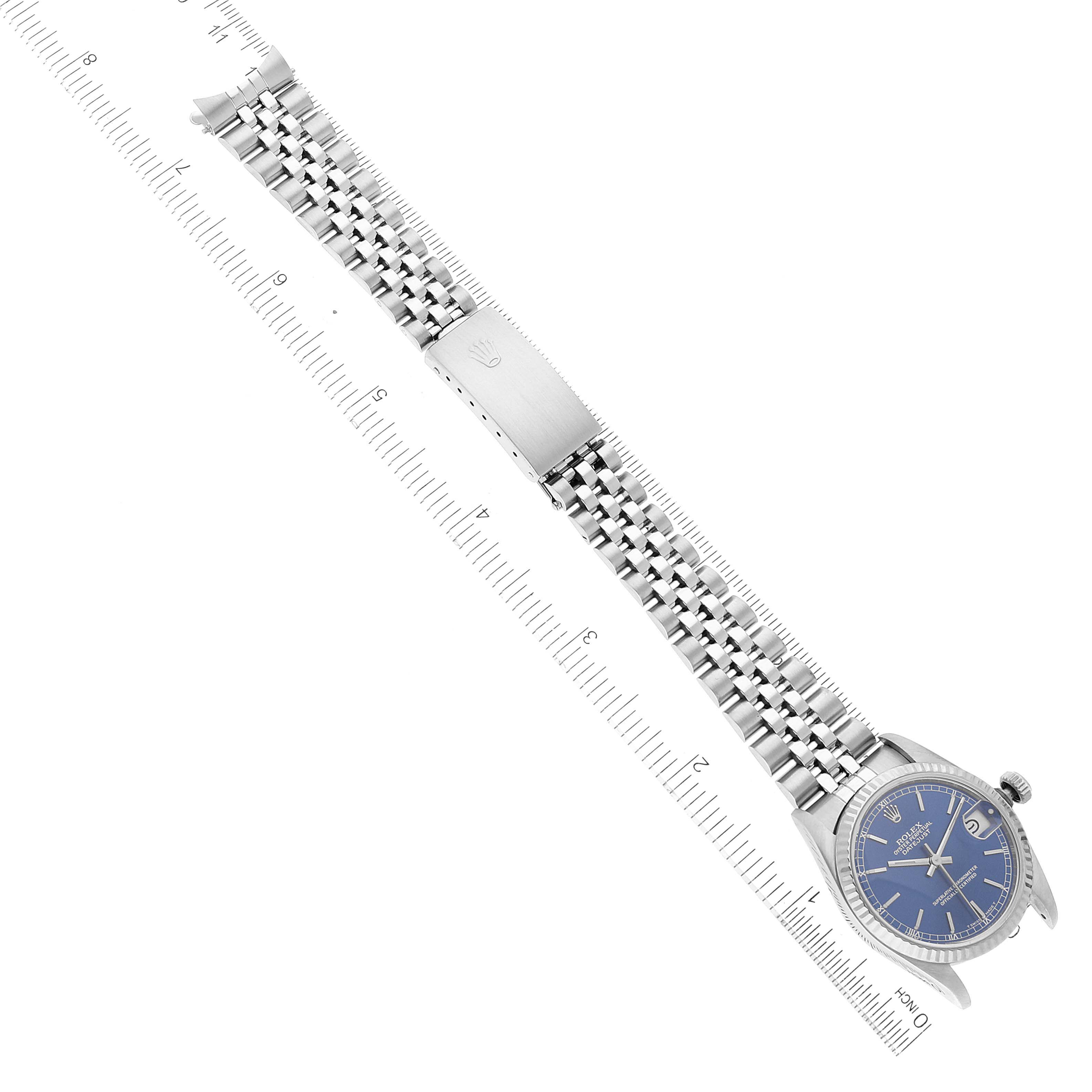 This image shows a Rolex Mid-Size 68274 Women
s Stainless Steel Blue Dial 68274 Women
s Stainless Steel Blue Dial watch laid flat, highlighting the face, bracelet, and clasp with a ruler for scale.