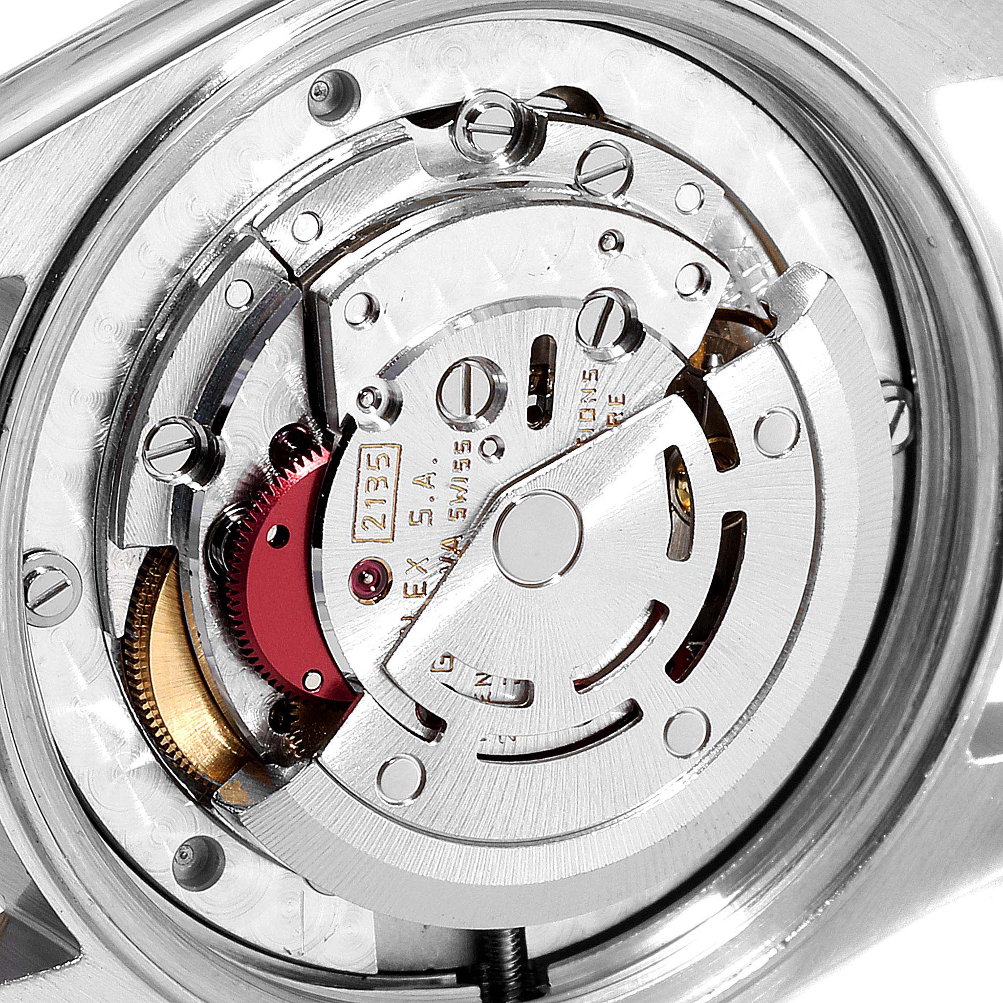 The image shows the inner mechanism of a Mid-Size Rolex watch from a close-up, top-down angle, highlighting its intricate components.