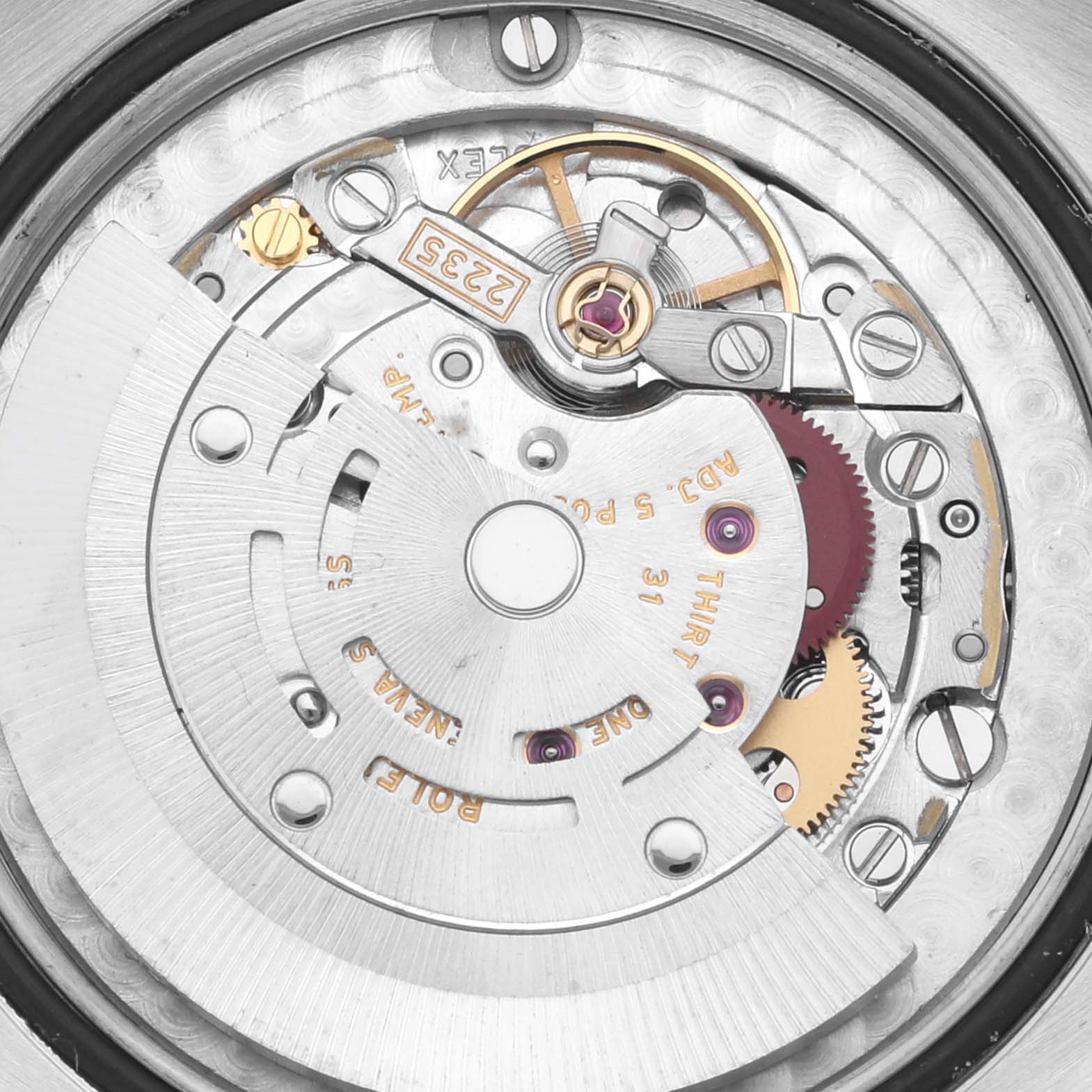 The image shows a close-up of the movement mechanism inside a Mid-Size Rolex watch.
