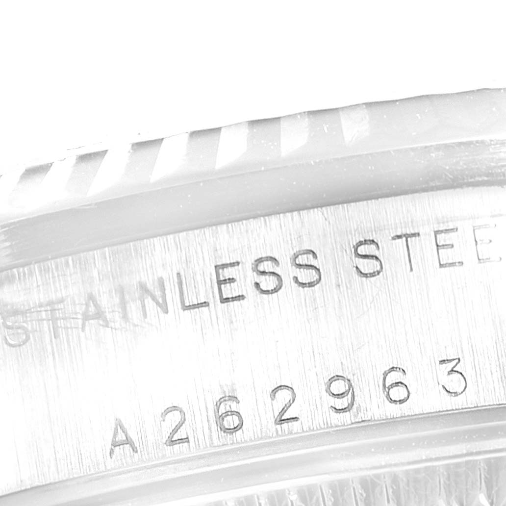 This close-up image of a Rolex Mid-Size 78274 Women
s Stainless Steel Blue Dial 78274 Women
s Stainless Steel Blue Dial model shows the engraved serial number and "STAINLESS STEEL" on the watch case.
