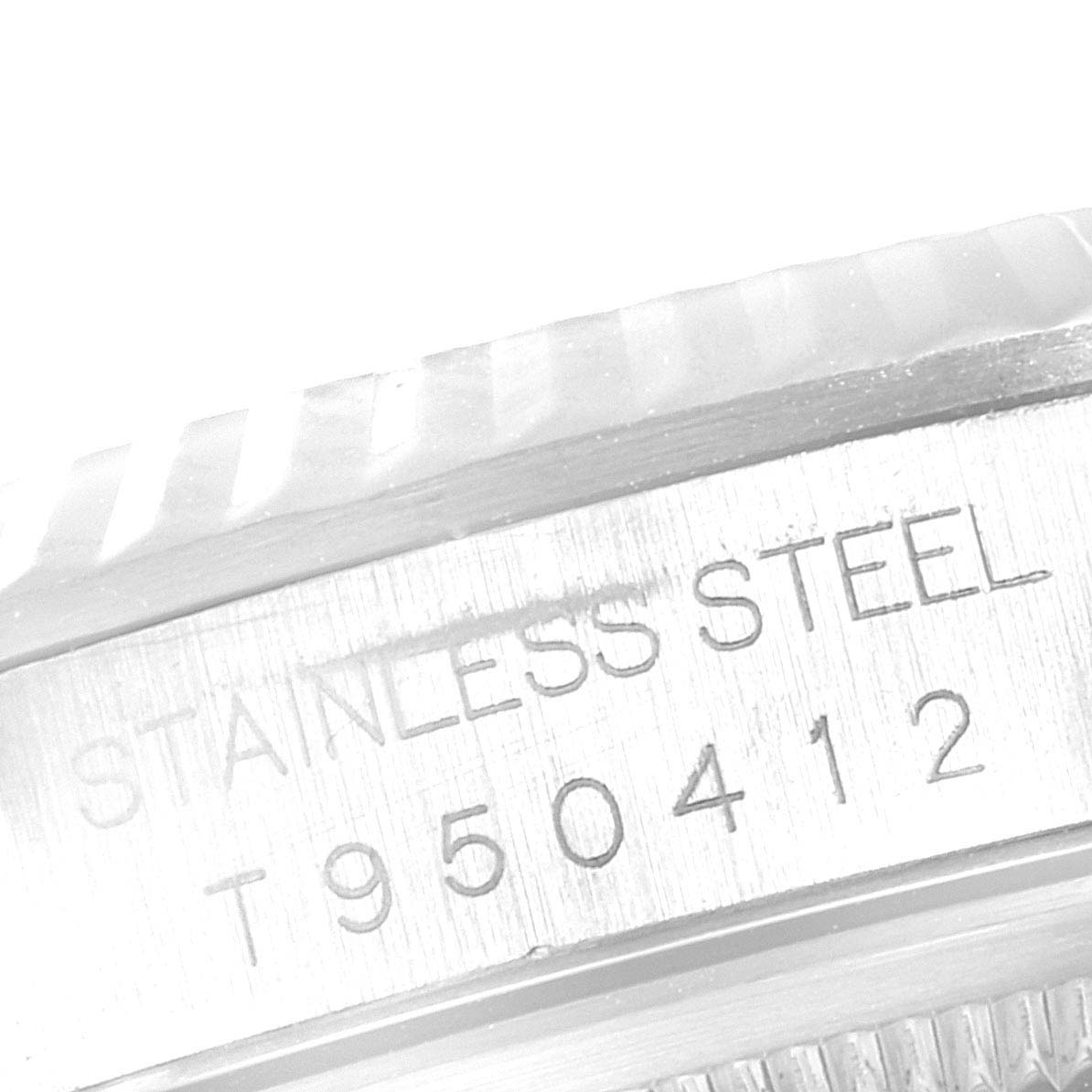 This image shows a close-up of the side of the Rolex Datejust 16234 Men's Stainless Steel Silver Dial 16234 Men's Stainless Steel Silver Dial watch case, highlighting the "STAINLESS STEEL" engraving and serial number.