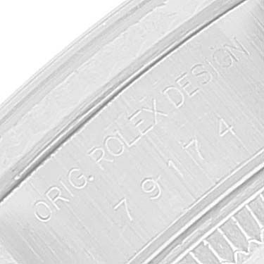 This close-up image shows the engraved serial number and design marking on the case of a Rolex Datejust 79174 Women's Stainless Steel Black Dial 79174 Women's Stainless Steel Black Dial watch.