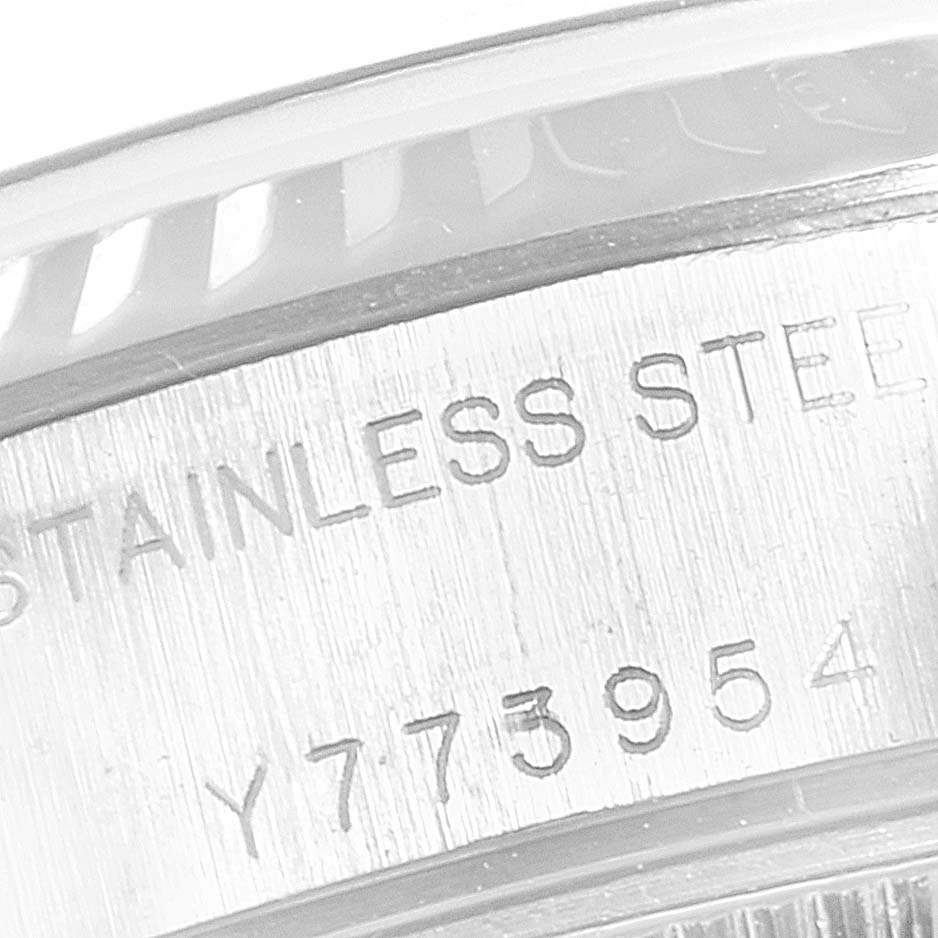 This image shows a close-up of the side of a Rolex Datejust 79174 Women
s Stainless Steel Silver Dial 79174 Women
s Stainless Steel Silver Dial watch, highlighting its stainless steel marking and partial serial number.