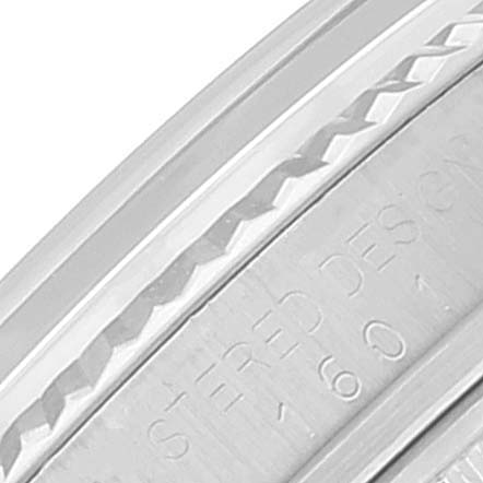 The image displays a close-up of the side case and bezel of a Vintage Collection Rolex watch.