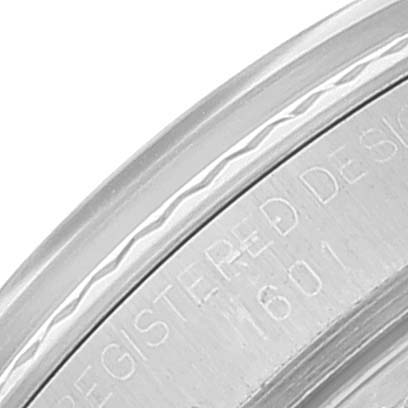 This image shows a close-up of the side of a Rolex Vintage Collection 1601 Men
s Stainless Steel Silver Dial 1601 Men
s Stainless Steel Silver Dial model watch, focusing on the engraved bezel and serial number.