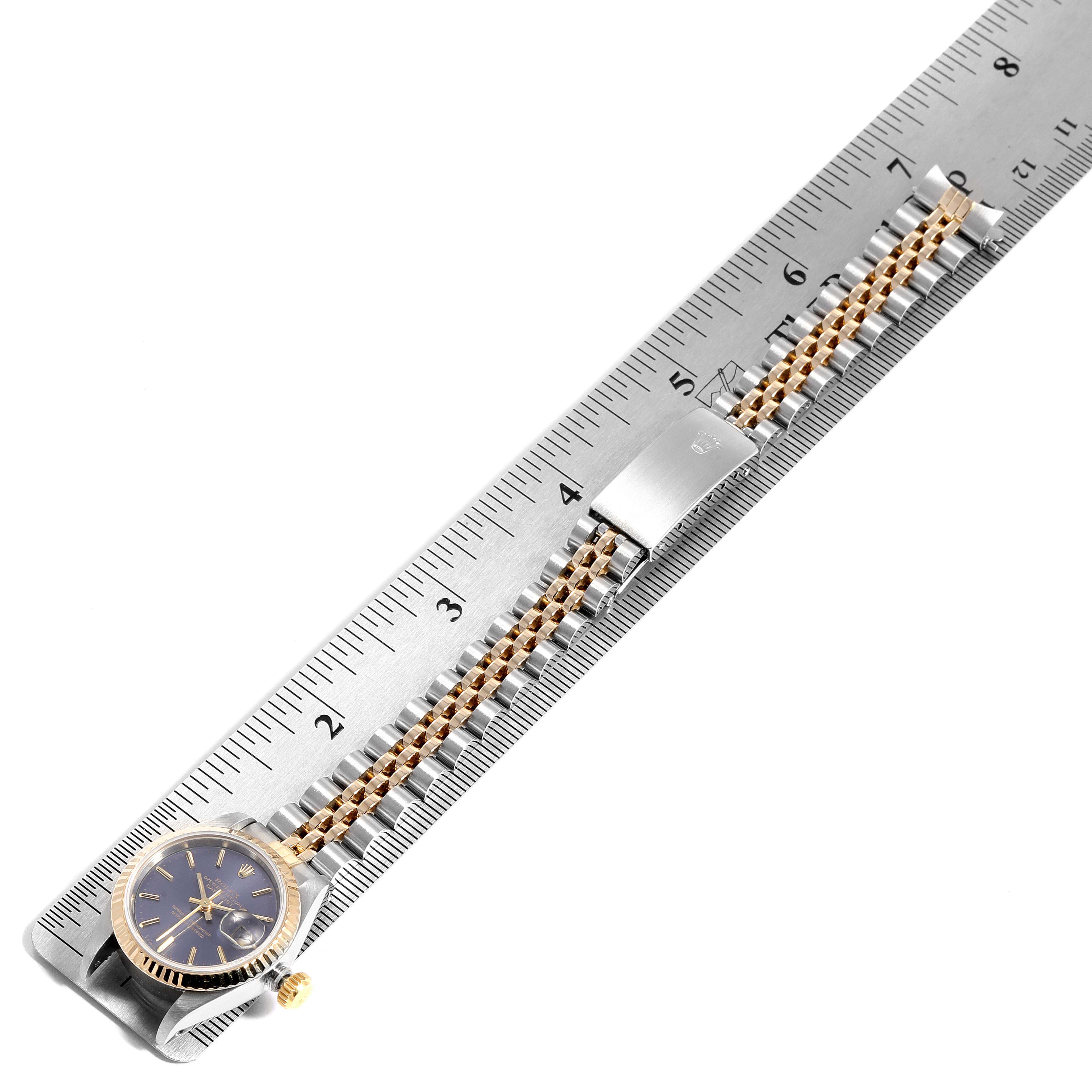 The image shows a side view of a Rolex Datejust 69173 Women's Steel and Gold (two tone) Blue Dial 69173 Women's Steel and Gold (two tone) Blue Dial watch with its bracelet laid out along a ruler.