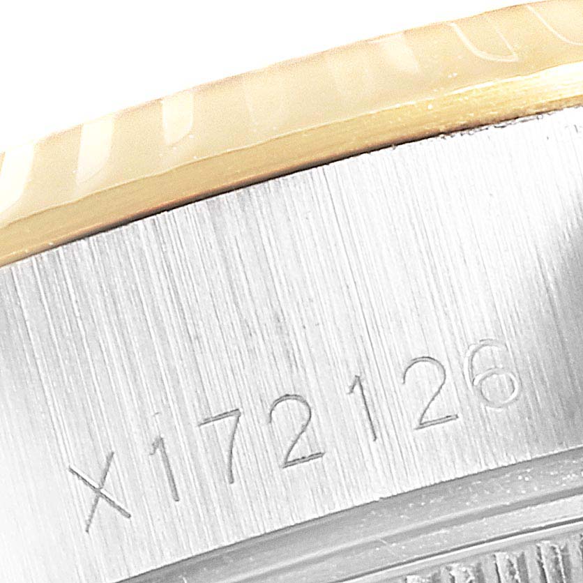 The image shows a close-up of the Rolex Datejust 69173 Women's Steel and Gold (two tone) Blue Dial 69173 Women's Steel and Gold (two tone) Blue Dial watch's bezel and part of its case, highlighting its unique serial number.