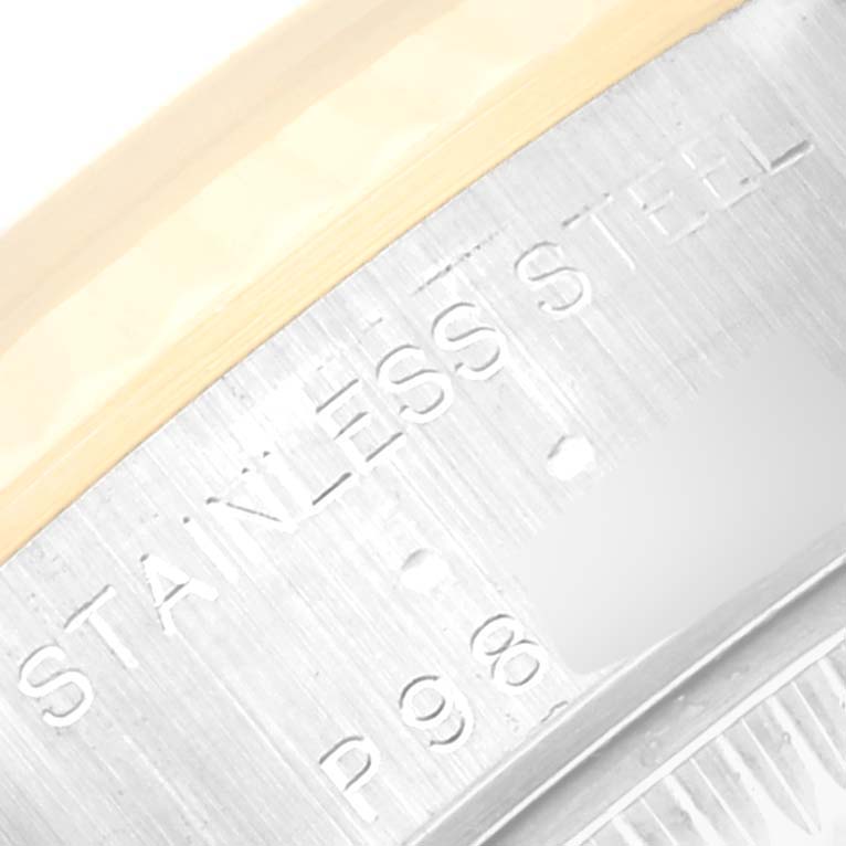 This close-up image shows the engraved text "STAINLESS STEEL" on the case back of a Rolex Datejust 79173 Women's Steel and Gold (two tone) Blue Dial 79173 Women's Steel and Gold (two tone) Blue Dial watch.