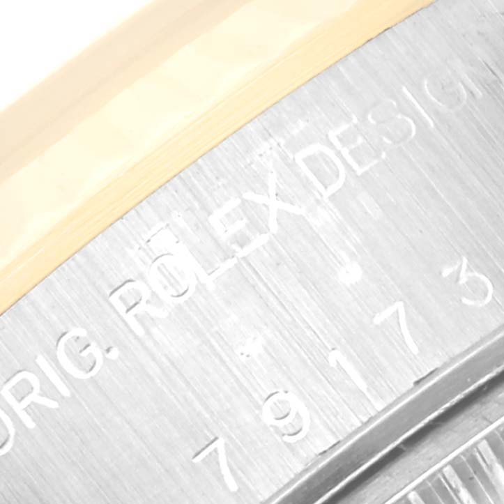 The image shows a close-up of the engraving on the side of the case of a Rolex Datejust 79173 Women's Steel and Gold (two tone) Blue Dial 79173 Women's Steel and Gold (two tone) Blue Dial watch.