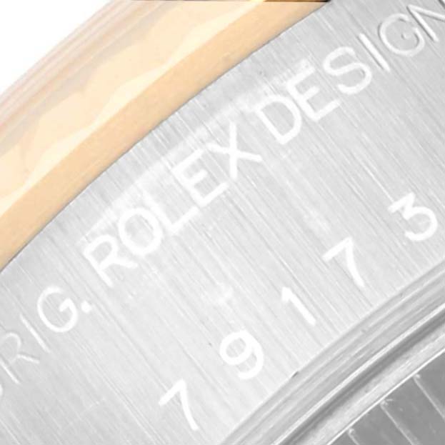 The image shows a close-up of the underside of a Rolex Datejust 79173 Women's Steel and Gold (two tone) Blue Dial 79173 Women's Steel and Gold (two tone) Blue Dial watch, highlighting the "Rolex Design" engraving and part of the serial number.