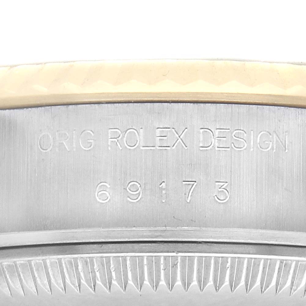 The image shows a close-up of the case side of a Rolex Datejust 69173 Women
s Steel and Gold (two tone) Champagne Dial 69173 Women
s Steel and Gold (two tone) Champagne Dial, featuring its model number and "Orig Rolex Design" engraving.