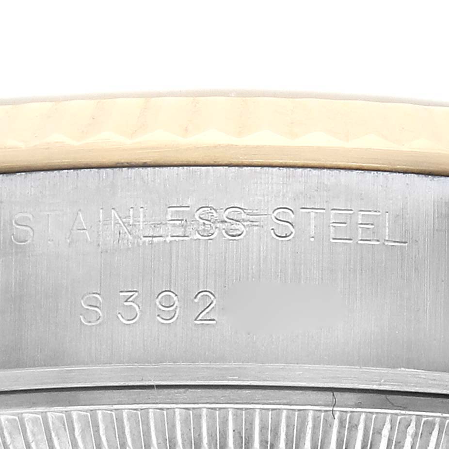 The image shows a close-up of the side of a Rolex Datejust 69173 Women
s Steel and Gold (two tone) Champagne Dial 69173 Women
s Steel and Gold (two tone) Champagne Dial watch, highlighting the stainless steel case with engraved details.