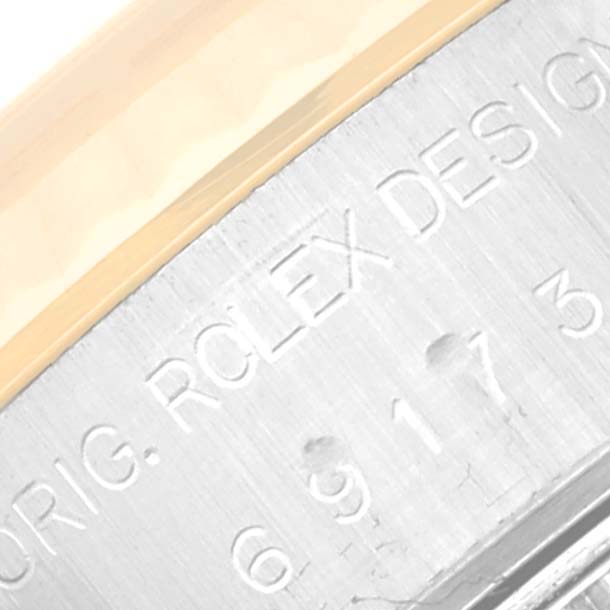The image shows a close-up of the engraving on the side of the Datejust Rolex watch casing.