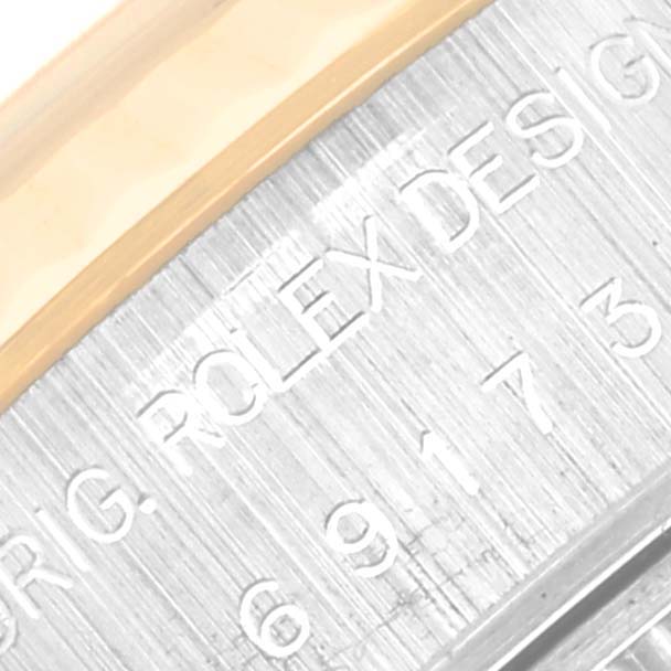 This close-up image shows the engraved details on the side of the bezel of a Rolex Datejust 69173 Women's Steel and Gold (two tone) Champagne Dial 69173 Women's Steel and Gold (two tone) Champagne Dial watch.