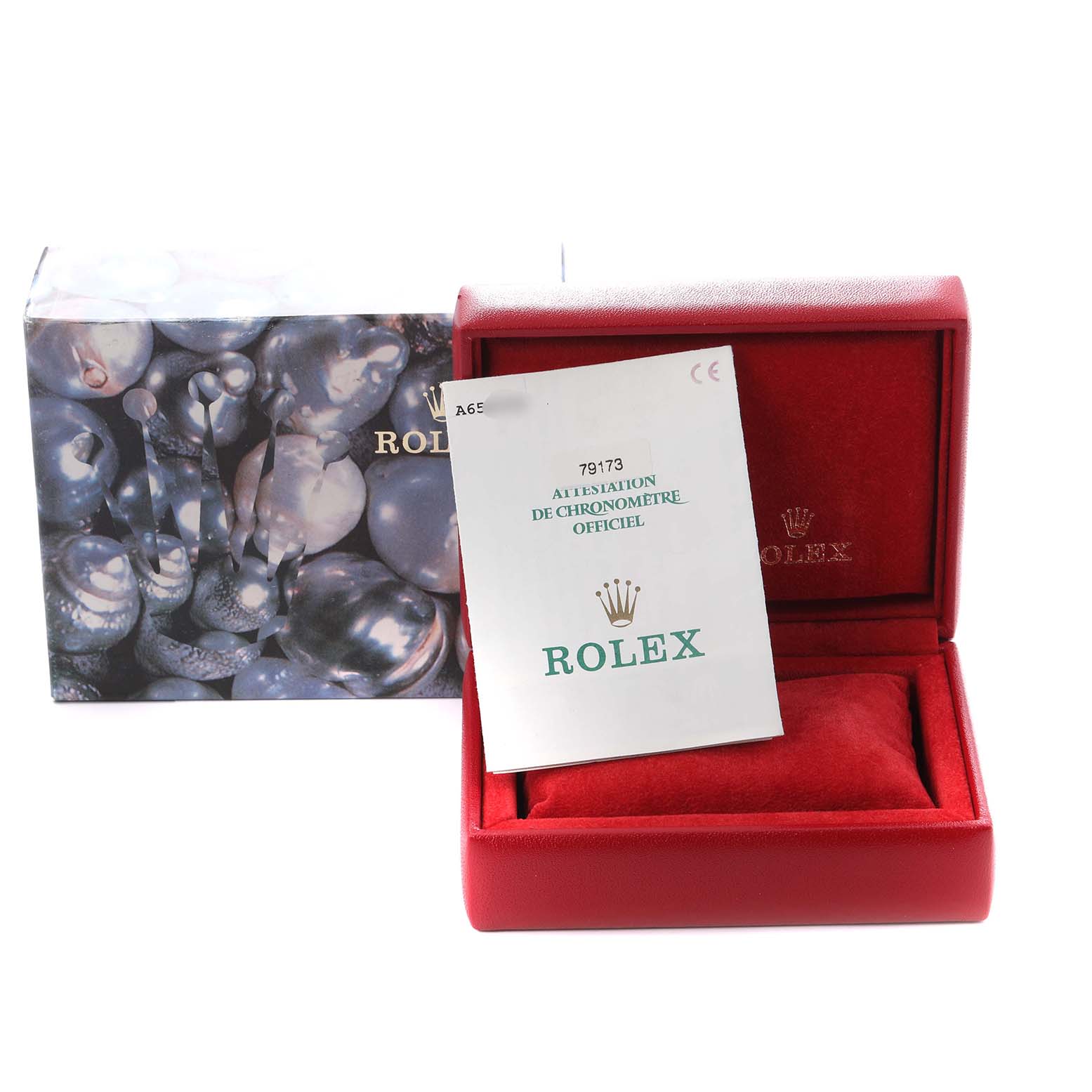 The image shows a Rolex Datejust 79173 Women
s Steel and Gold (two tone) White Dial 79173 Women
s Steel and Gold (two tone) White Dial box and certificate, featuring the packaging and documentation at an angle.