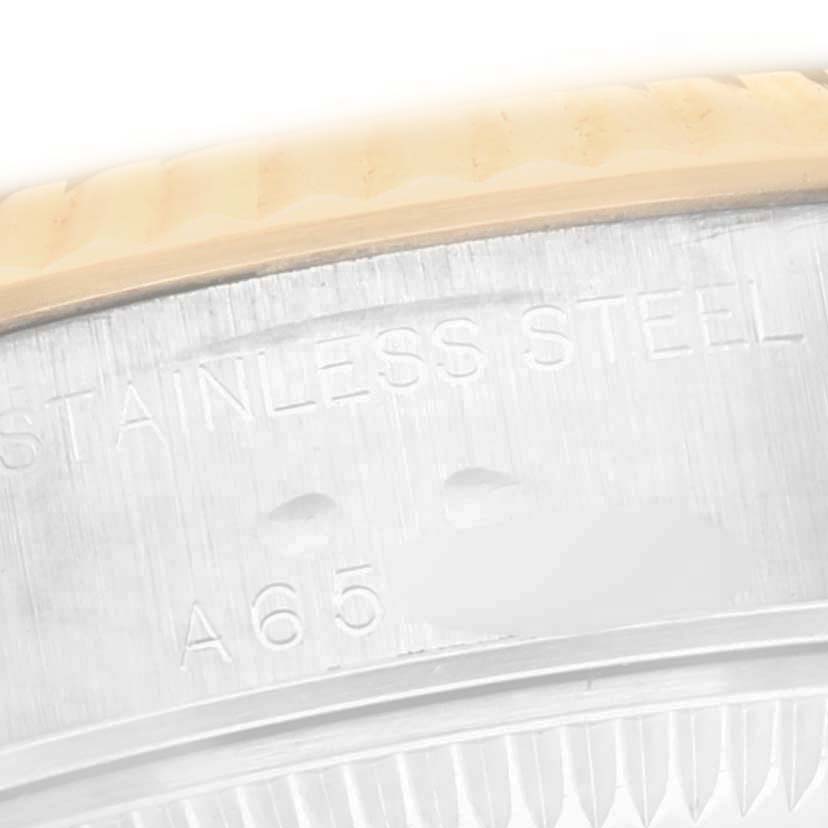 The image shows a close-up of the side of the bezel and case of a Rolex Datejust 79173 Women
s Steel and Gold (two tone) White Dial 79173 Women
s Steel and Gold (two tone) White Dial watch, highlighting the stainless steel material.