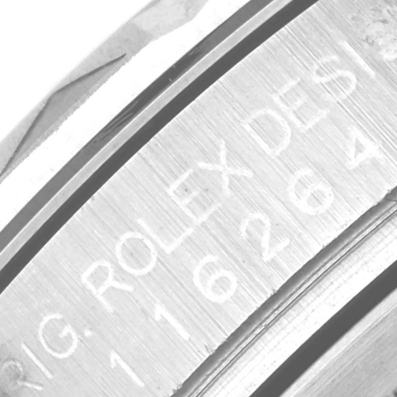 This close-up shot of a Rolex Turn-o-Graph 116264 Men's Stainless Steel Black Dial 116264 Men's Stainless Steel Black Dial watch focuses on the engraved outer ring around the bezel.