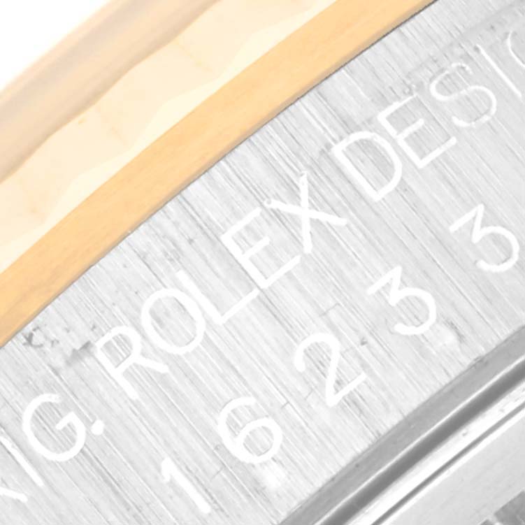 The image shows a close-up of the side engraving on a Rolex Datejust 16233 Men's Steel and Gold (two tone) Blue Dial 16233 Men's Steel and Gold (two tone) Blue Dial watch, revealing part of the model number.