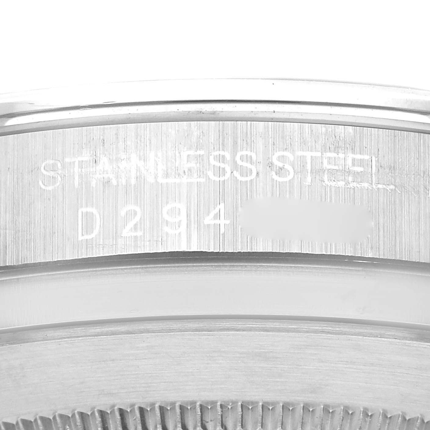 The image shows a close-up of the case back edge of a Rolex Daytona 116520 Men's Stainless Steel Black Dial 116520 Men's Stainless Steel Black Dial, revealing its stainless steel material and a partial serial number.