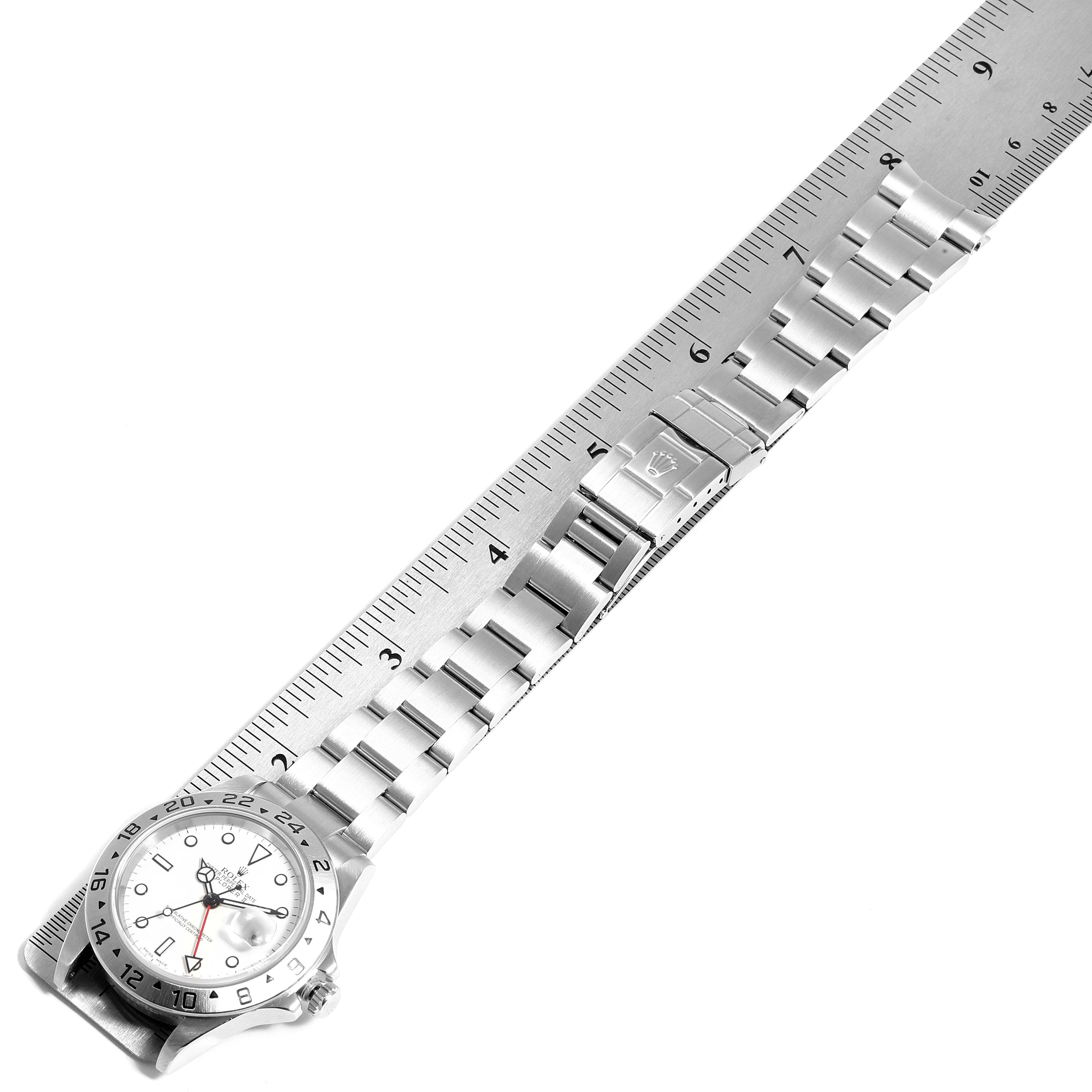 The image shows a Rolex Explorer 16570 Men
s Stainless Steel White Dial 16570 Men
s Stainless Steel White Dial watch laid flat with its bracelet extended, next to a ruler for measurement.