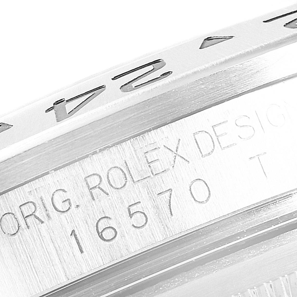 The image shows a close-up of the case side of a Rolex Explorer 16570 Men
s Stainless Steel White Dial 16570 Men
s Stainless Steel White Dial, focusing on the model number 16570 and the engraved bezel.