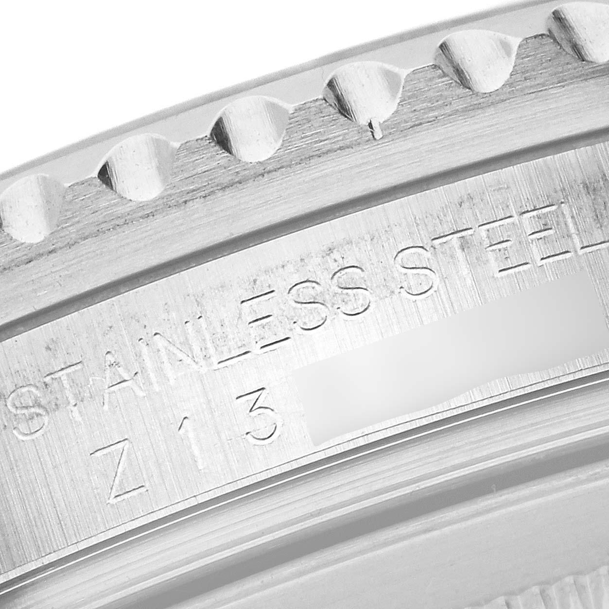 This close-up image shows part of the bezel and the engraved case of a Rolex GMT-Master 16710 Men
s Stainless Steel Black Dial 16710 Men
s Stainless Steel Black Dial watch.