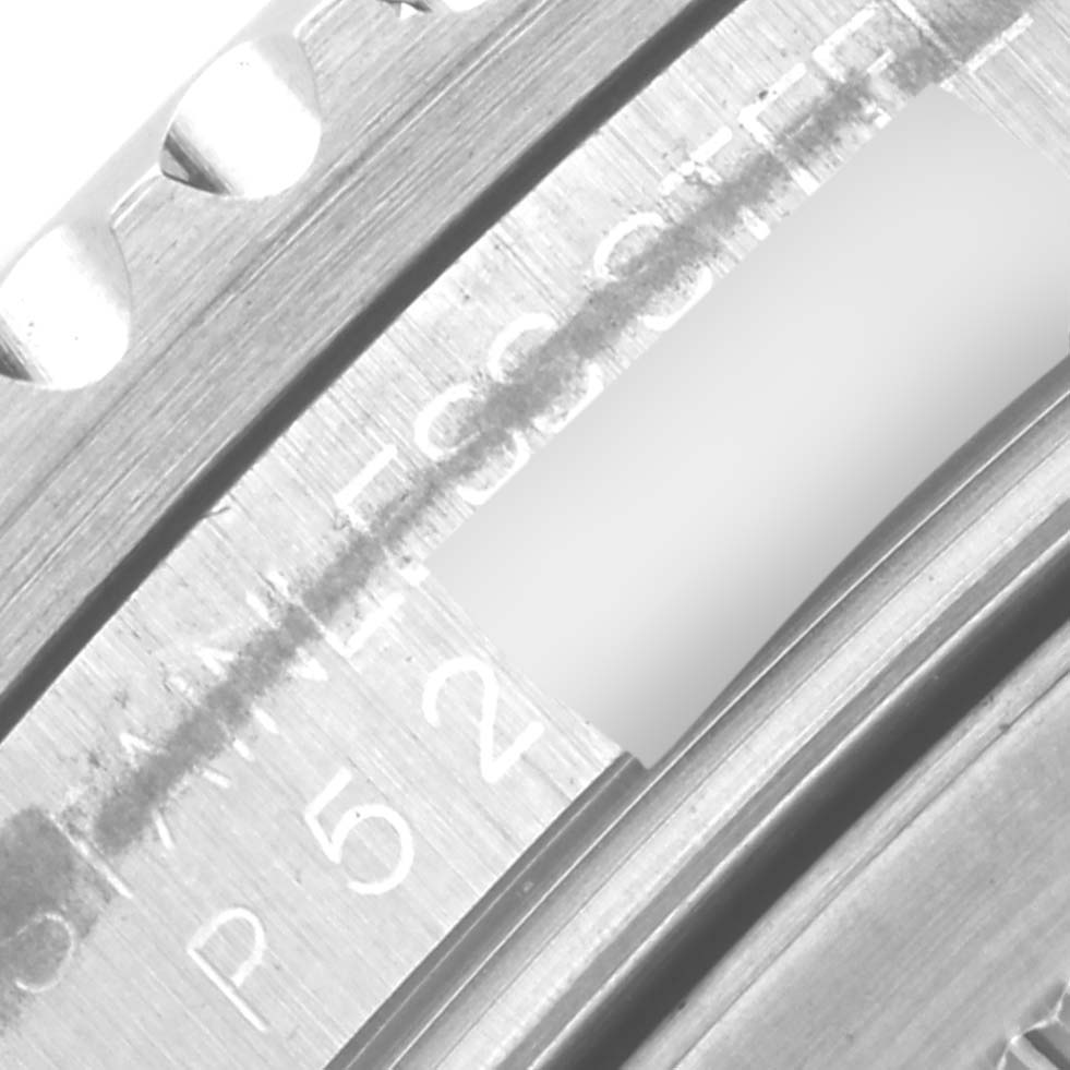 Close-up of the bezel and serial number area of a Rolex GMT-Master 16710 Men's Stainless Steel Black Dial 16710 Men's Stainless Steel Black Dial watch.