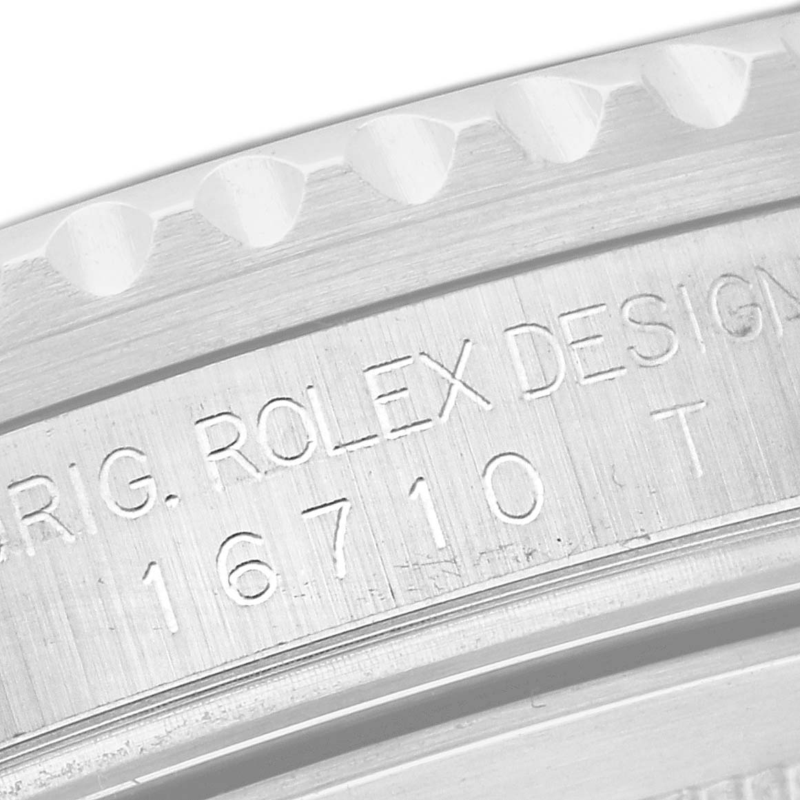 The image shows a close-up of the engraved inner bezel of a Rolex GMT-Master 16710 Men
s Stainless Steel Black Dial 16710 Men
s Stainless Steel Black Dial watch, displaying the model number 16710T.