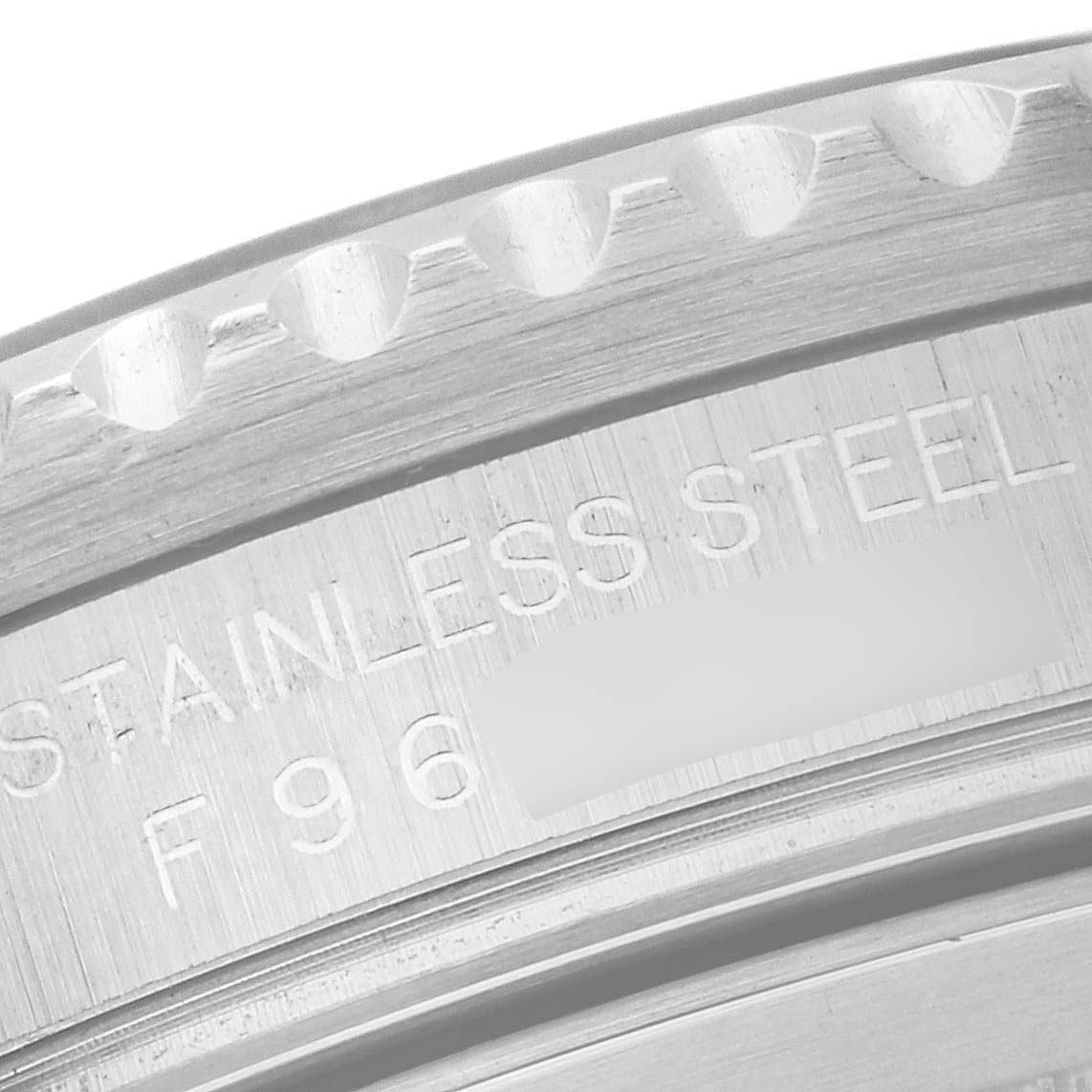 This image shows a close-up of the case back of a Rolex GMT-Master 16710 Men
s Stainless Steel Black Dial 16710 Men
s Stainless Steel Black Dial watch, highlighting the "STAINLESS STEEL" engraving.