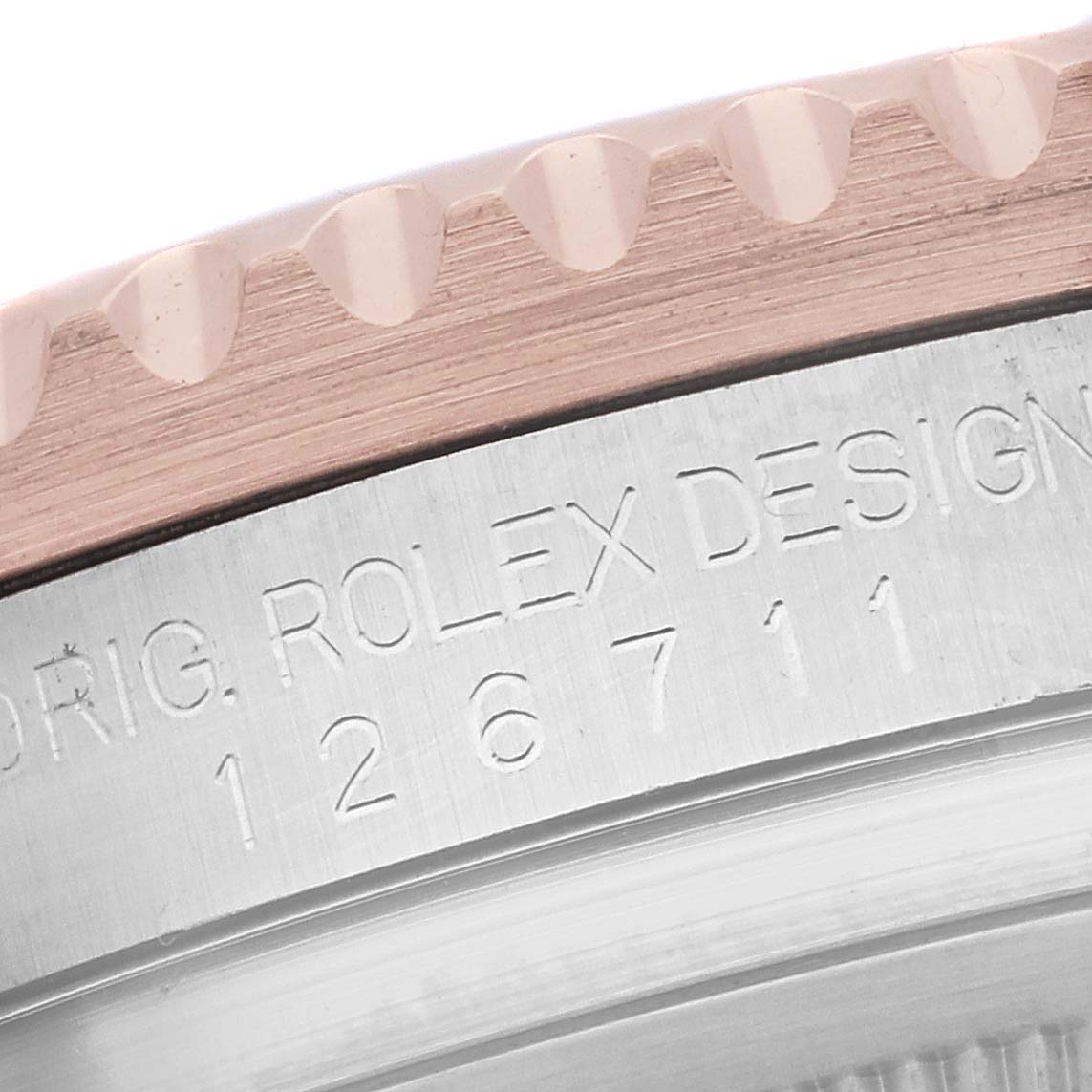 This image shows a close-up of the case side and bezel edge of a Rolex GMT-Master 126711CHNR Men's Steel and Gold (two tone) Black Dial 126711CHNR Men's Steel and Gold (two tone) Black Dial, showcasing the model number engraving.