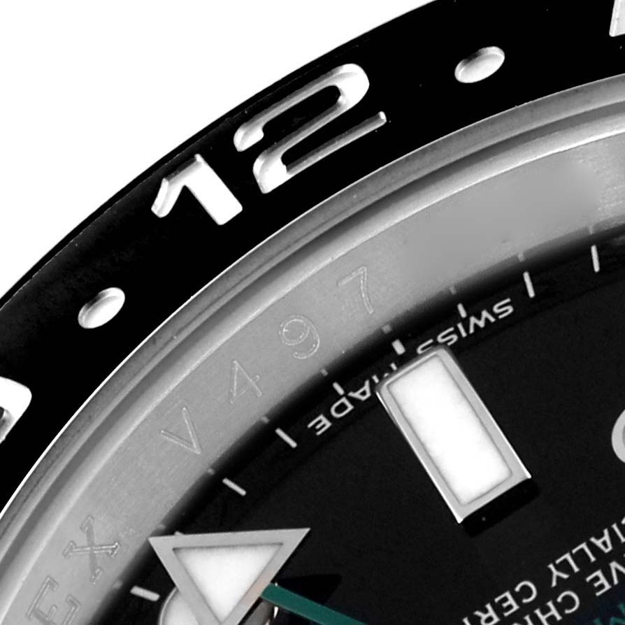 This close-up image of a Rolex GMT-Master 116710 Men
s Stainless Steel Black Dial 116710 Men
s Stainless Steel Black Dial shows the bezel, part of the dial, and hour markers at an angle.