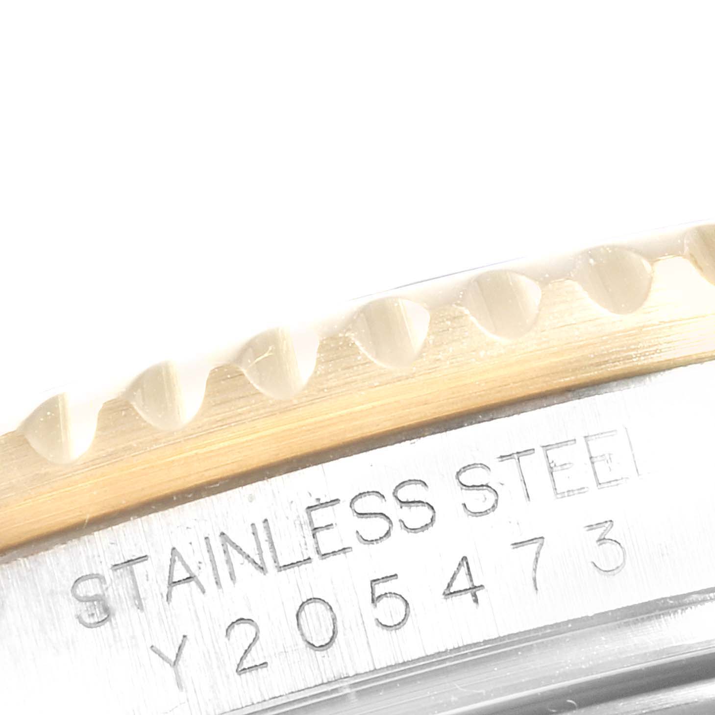 This image shows the engraved side of the stainless steel case and the edge of the bezel of a Rolex GMT-Master 16713 Men
s Steel and Gold (two tone) Black Dial 16713 Men
s Steel and Gold (two tone) Black Dial watch.