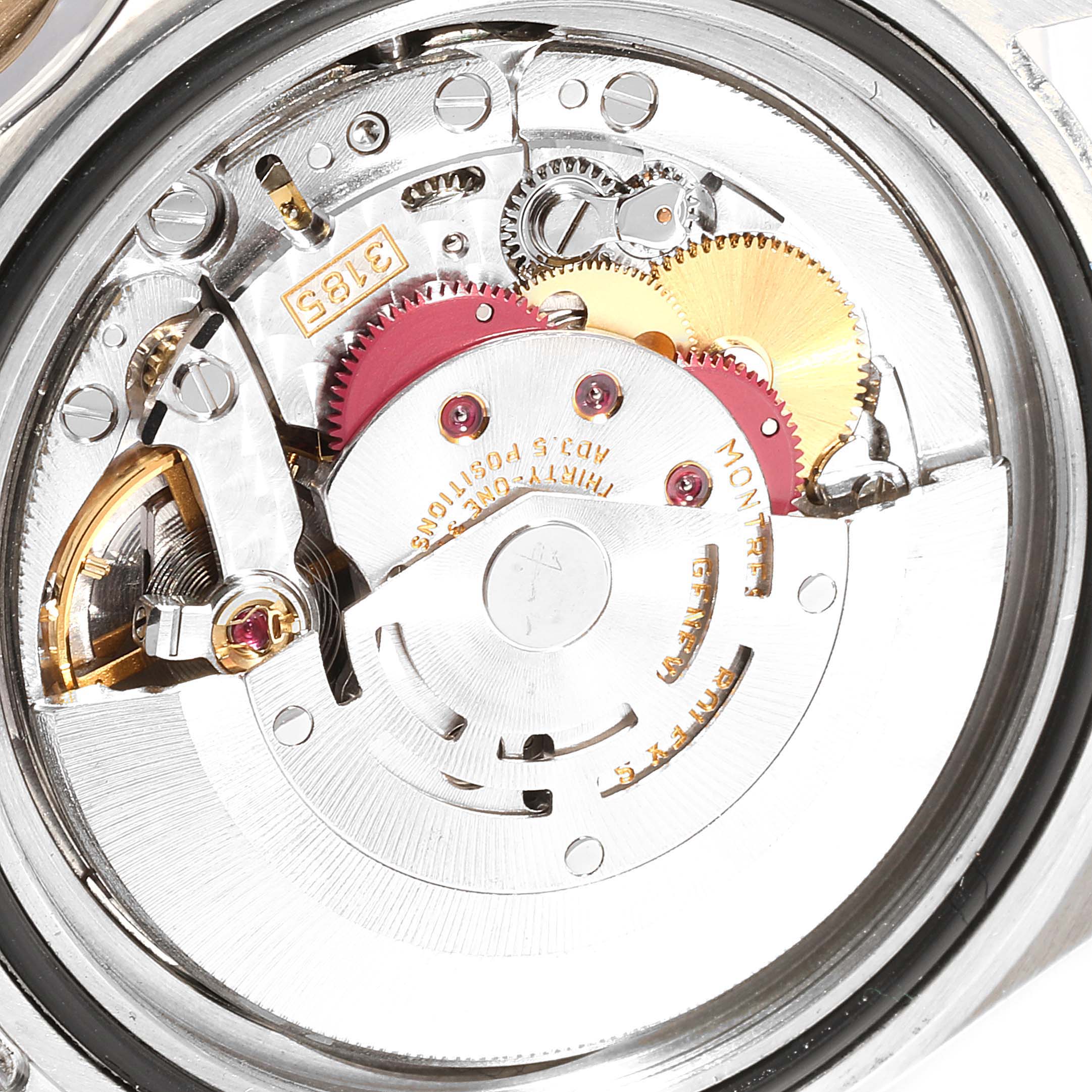 This image shows the intricate inner mechanism of a Rolex GMT-Master 16713 Men
s Steel and Gold (two tone) Black Dial 16713 Men
s Steel and Gold (two tone) Black Dial watch from a close-up angle.