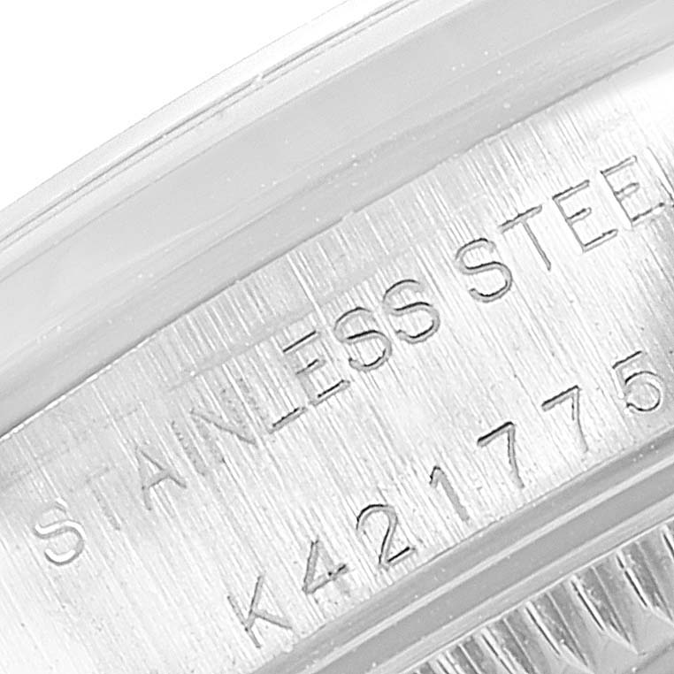This image shows a close-up of the stainless steel case back and engraved serial number on a Rolex Oyster Perpetual 76080 Women's Stainless Steel Pink Dial 76080 Women's Stainless Steel Pink Dial watch.