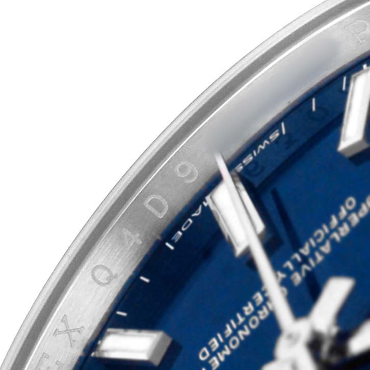 The image shows a close-up of the Rolex Oyster Perpetual M124200-0003 Men's Stainless Steel Blue Dial watch, highlighting part of the blue dial, hands, and bezel.