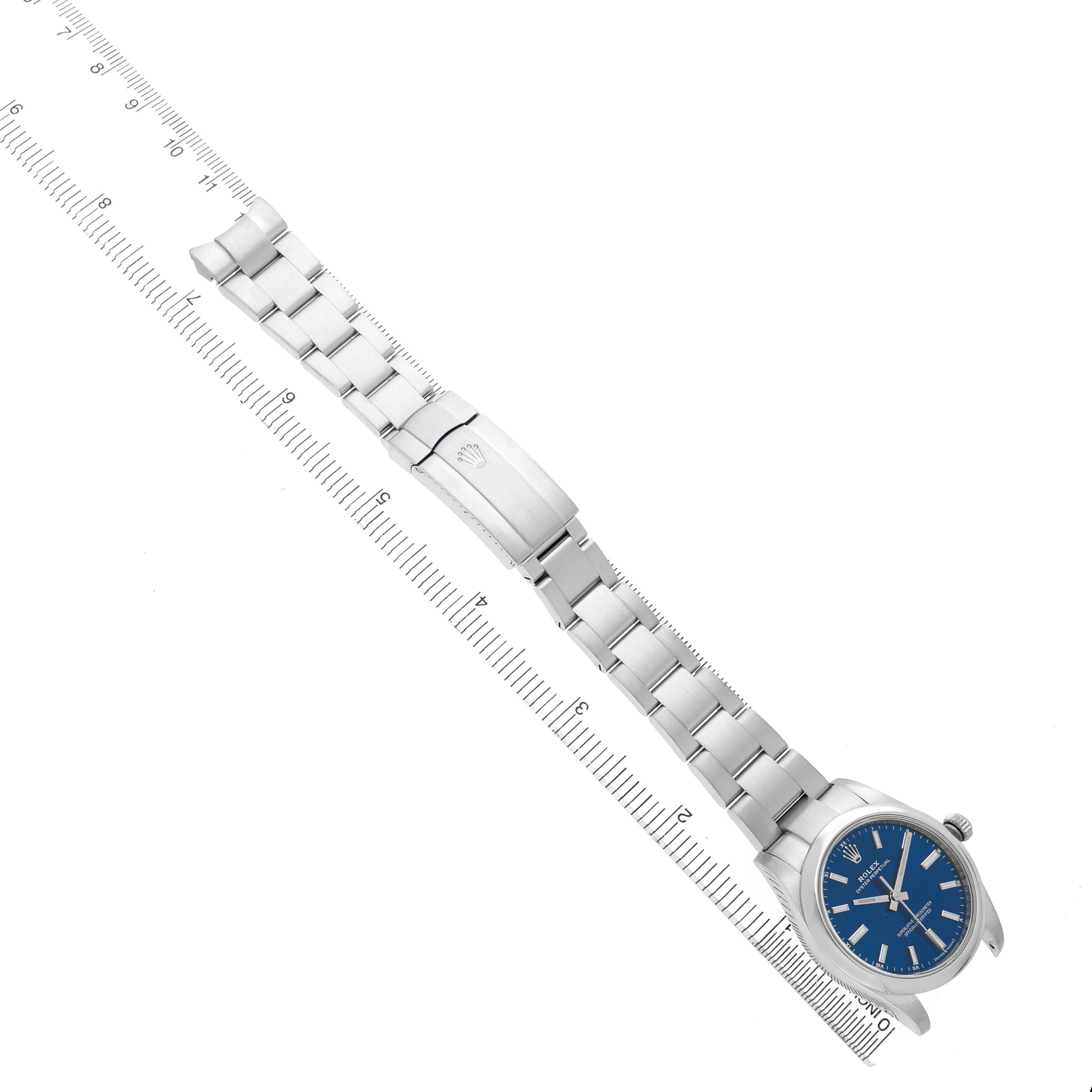 The Rolex Oyster Perpetual M124200-0003 Men's Stainless Steel Blue Dial watch is shown laid flat with its bracelet extended, featuring a blue dial and clasp visible.