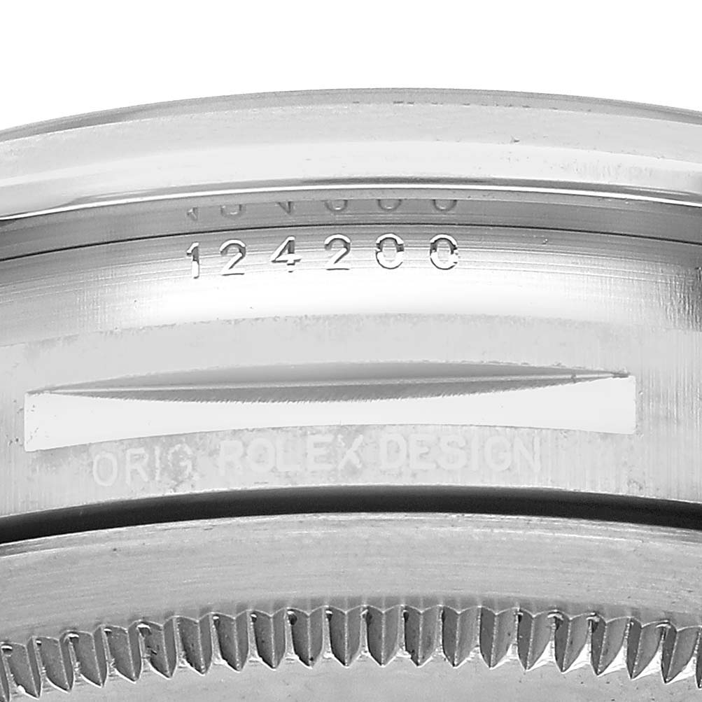 The image shows the side view of the bezel and case engraving details of the Rolex Oyster Perpetual M124200-0003 Men's Stainless Steel Blue Dial watch.