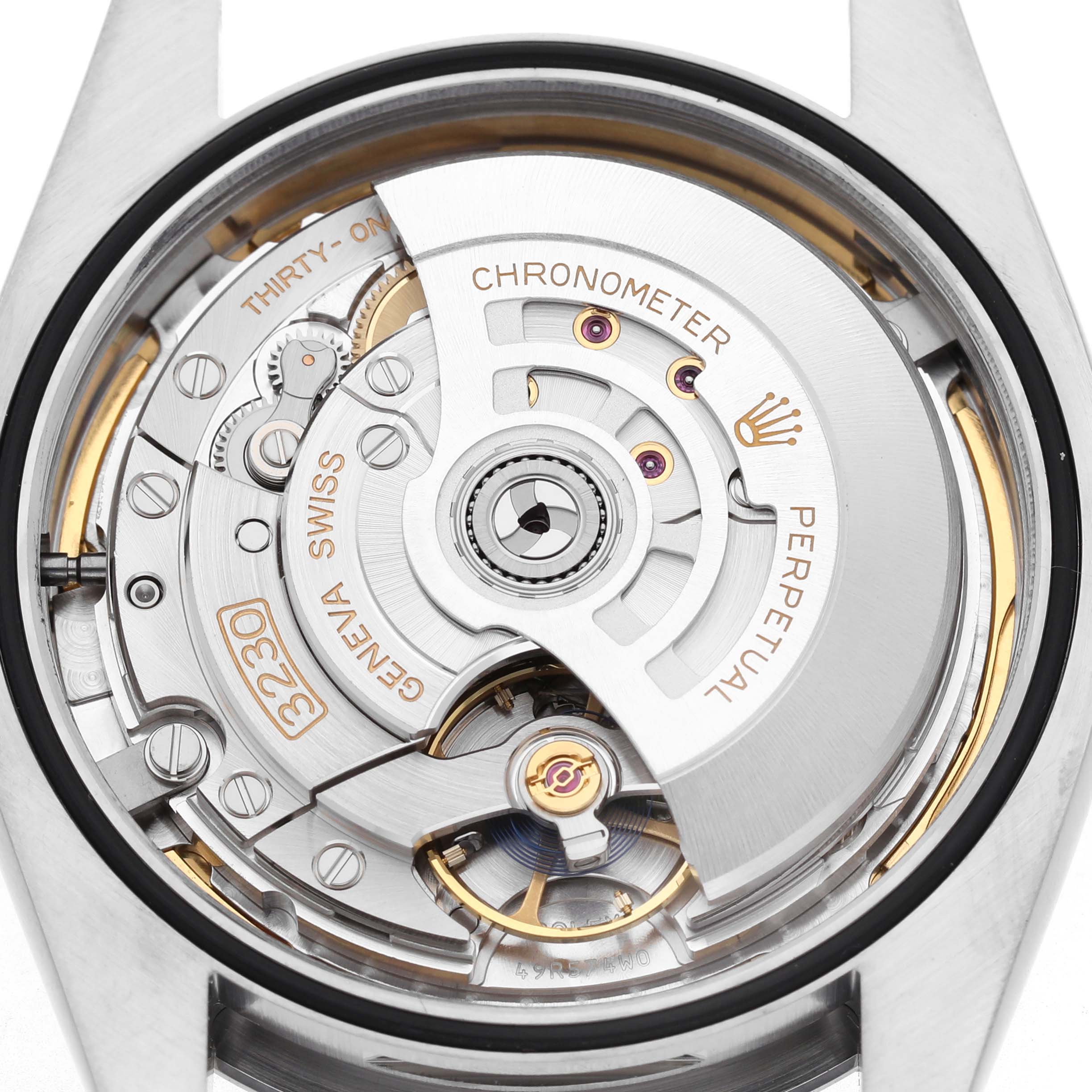 The Rolex Oyster Perpetual 124300 Men's Stainless Steel Blue Dial is shown from the back, highlighting its movement and rotor mechanism.