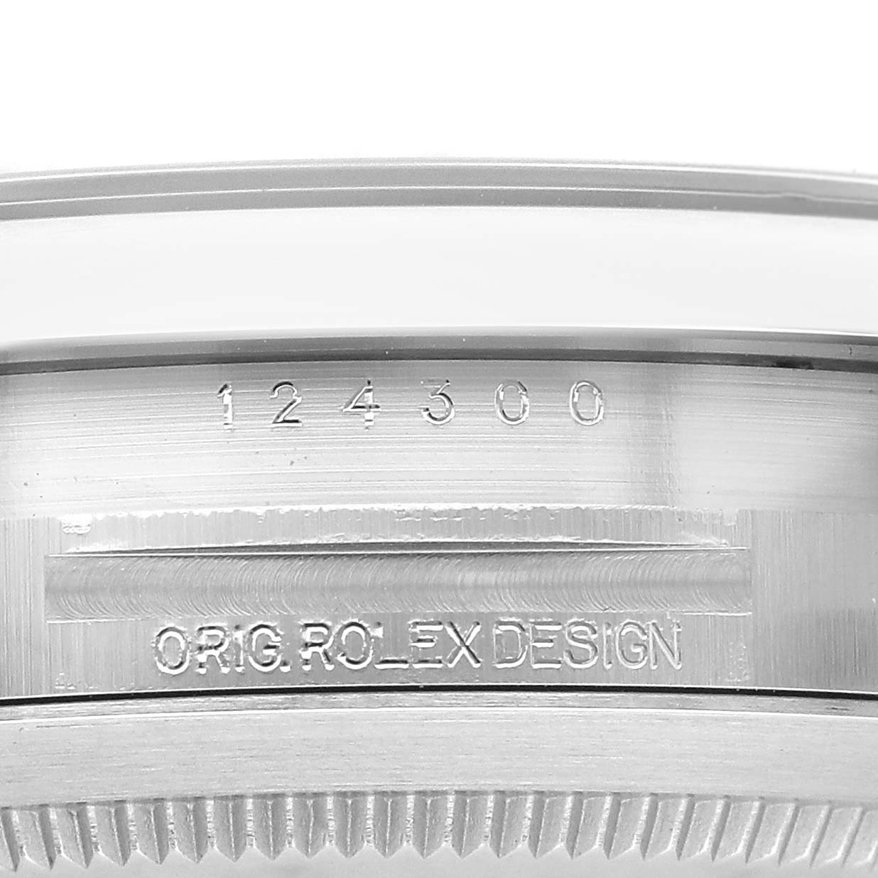 The image shows a close-up of the case side of a Rolex Oyster Perpetual 124300 Men's Stainless Steel Blue Dial, highlighting the model number "124300" and "ORIG. ROLEX DESIGN" engraving.