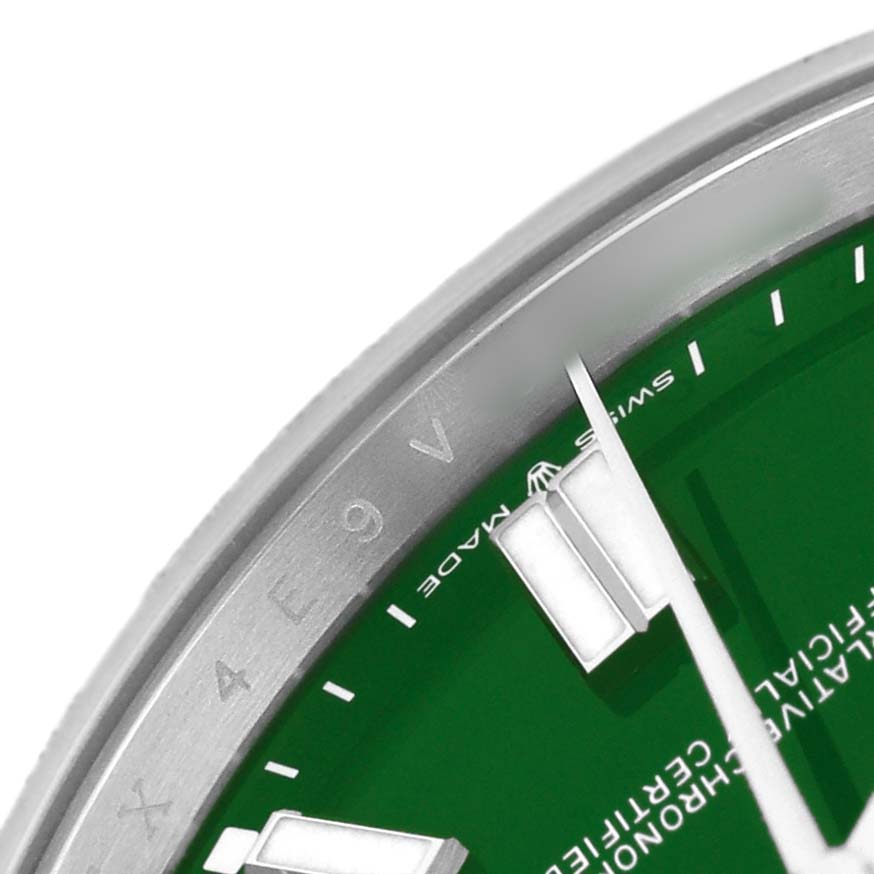 The image shows a close-up of the dial and bezel of the Rolex Oyster Perpetual M124300-0005 Men's Stainless Steel Green Dial, highlighting the green face and markers.