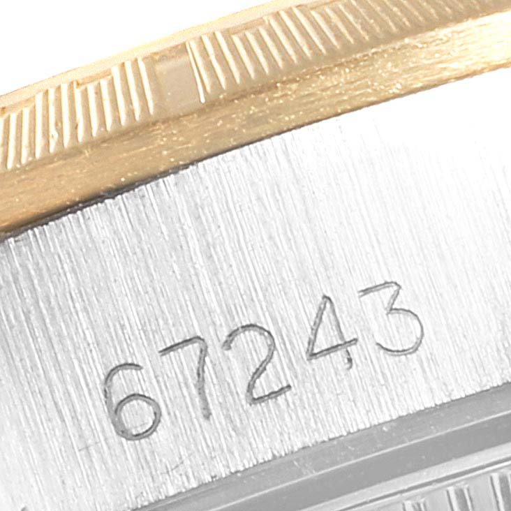 This is a close-up of the engraved serial number on the bezel and case of the Rolex Oyster Perpetual 67243 Women
s Steel and Gold (two tone) Champagne Dial 67243 Women
s Steel and Gold (two tone) Champagne Dial watch.