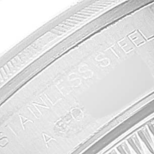 The image shows a close-up of the case back edge of a Rolex Oyster Perpetual 76030 Women
s Stainless Steel Pink Dial 76030 Women
s Stainless Steel Pink Dial watch, displaying the "STAINLESS STEEL" engraving.